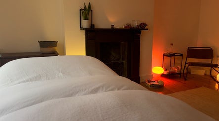 Calm treatment room at House of Kush-Kush, London, GB, featuring cozy decor and ambient lighting.