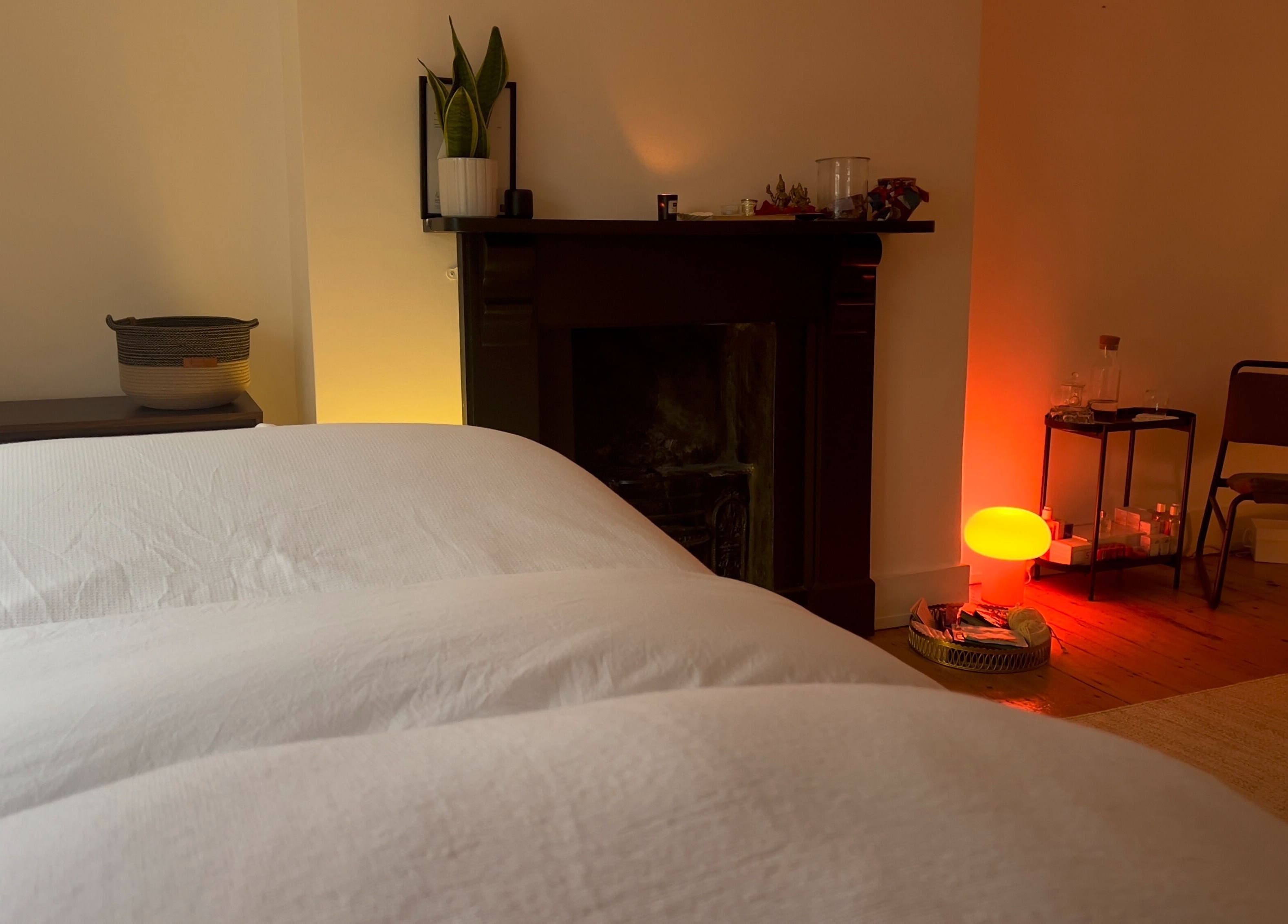 Relaxing therapy room at House of Kush-Kush, London, GB, featuring a cozy bed and ambient lighting.