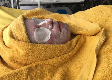 Facial treatment at Unique Beauty & Aesthetics, Rhosllanerchrugog, Wales, GB. Luxurious yellow towel wrap.