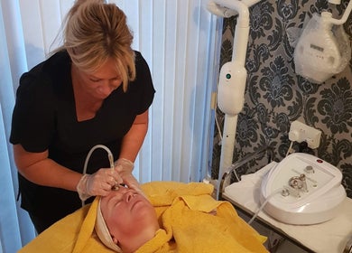 Facial treatment at Unique beauty & aesthetics in Rhosllanerchrugog, Wales, GB. Aesthetician using advanced equipment.