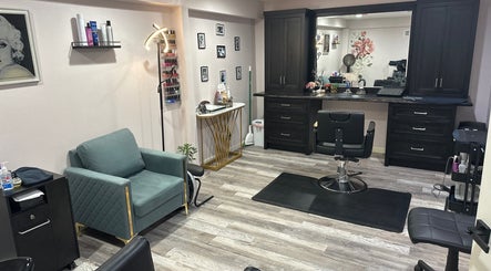 Modern salon interior at Rachael Fratzel, Kansas City, Kansas, US with chair, mirror, and decor.