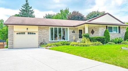 Exterior view of Shawna Stemmler RMT's welcoming venue in Kitchener, Ontario, CA, showcasing lush greenery and a serene atmosphere.