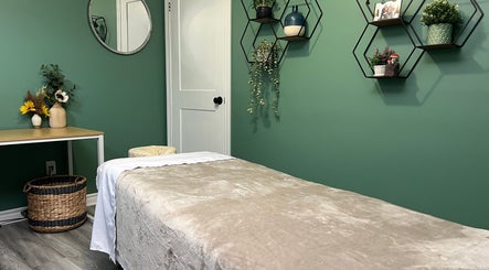 Serene massage room at Shawna Stemmler RMT in Kitchener, Ontario, CA showcasing a peaceful green decor.