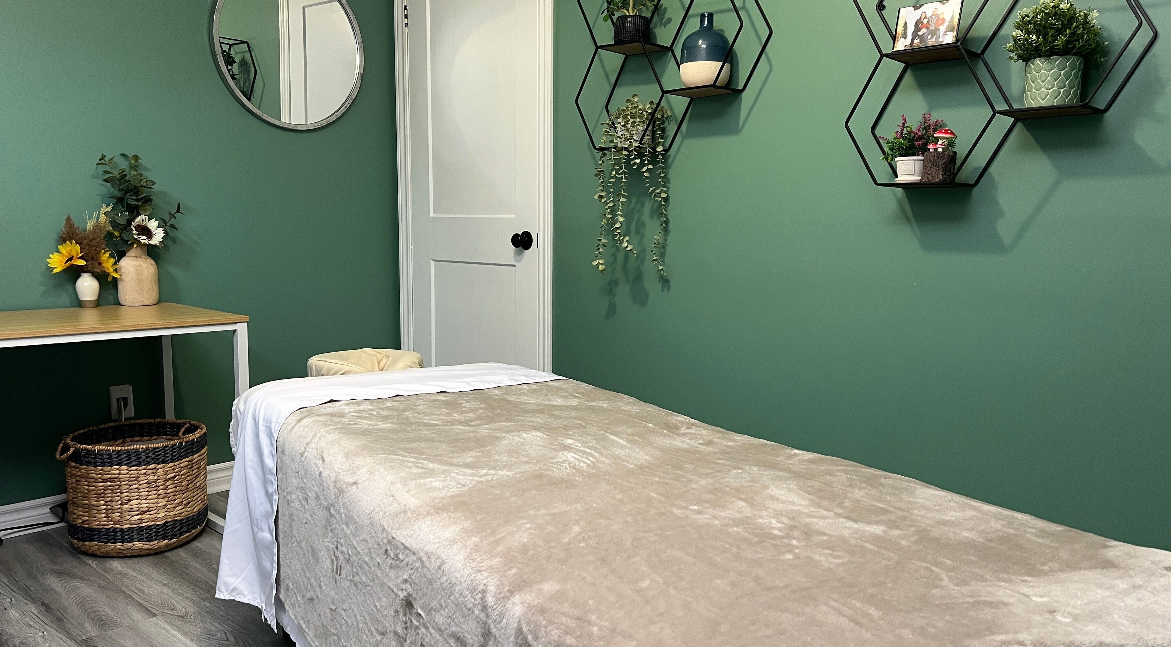 Cozy massage room at Shawna Stemmler RMT in Kitchener, Ontario, CA with green decor and calming ambiance.