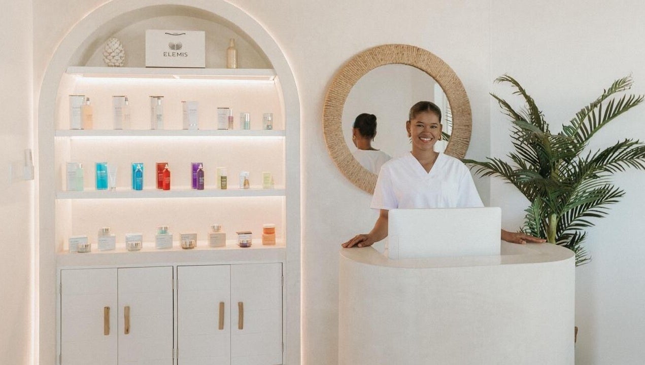 Reception area of The Cure, Tortola, with smiling staff and beauty products on display, Tortola, VG.