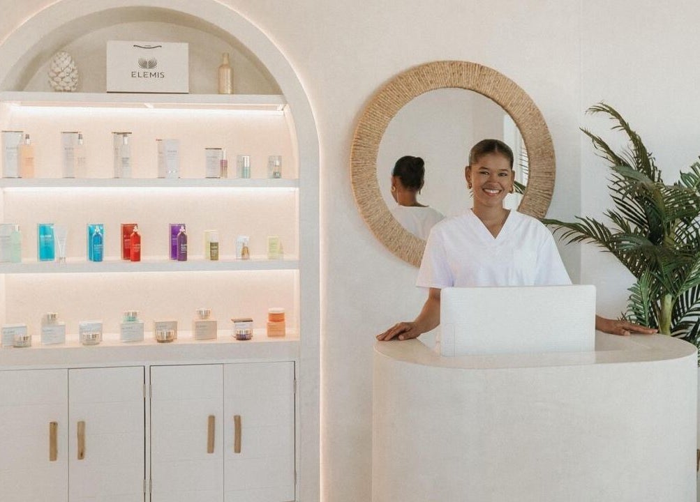 Reception area of The Cure, Tortola, with smiling staff and beauty products on display, Tortola, VG.