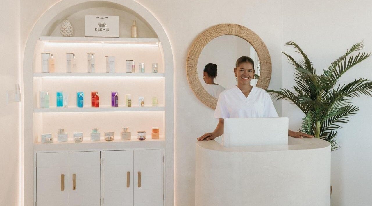 Reception area of The Cure, Tortola, with smiling staff and beauty products on display, Tortola, VG.
