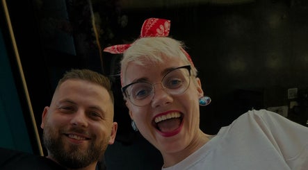 Smiling individuals at LapsaBarber\M.Nometņu iela 45A in Rīga, LV, showcasing vibrant atmosphere.