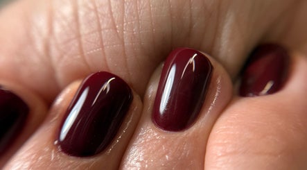 Stylish dark red manicure by Ana Fernandes, Dublin 01, IE, showcasing glossy nail finish.