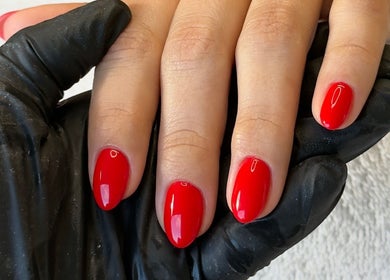 Ana Fernandes offers vibrant red manicure in Dublin, Dublin 01, IE, highlighting sleek nail artistry.