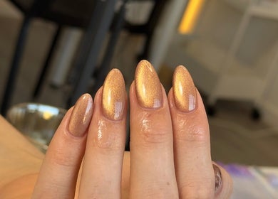 Golden shimmer manicured nails at Ana Fernandes, Dublin, Dublin 01, IE. Perfect for elegance and style.