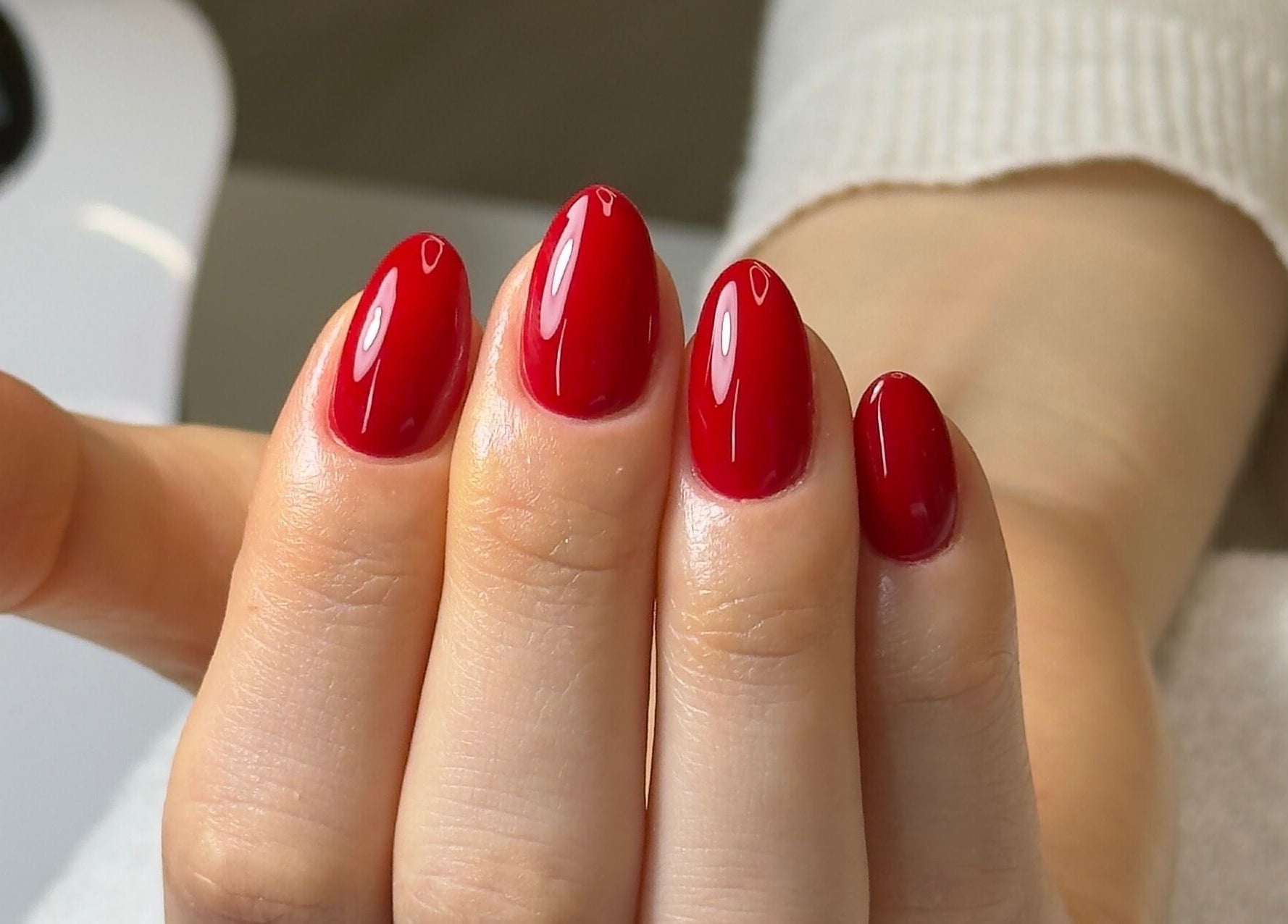 Glossy red nails at Ana Fernandes, Dublin 01, IE. Experience luxury nail care in a serene environment.