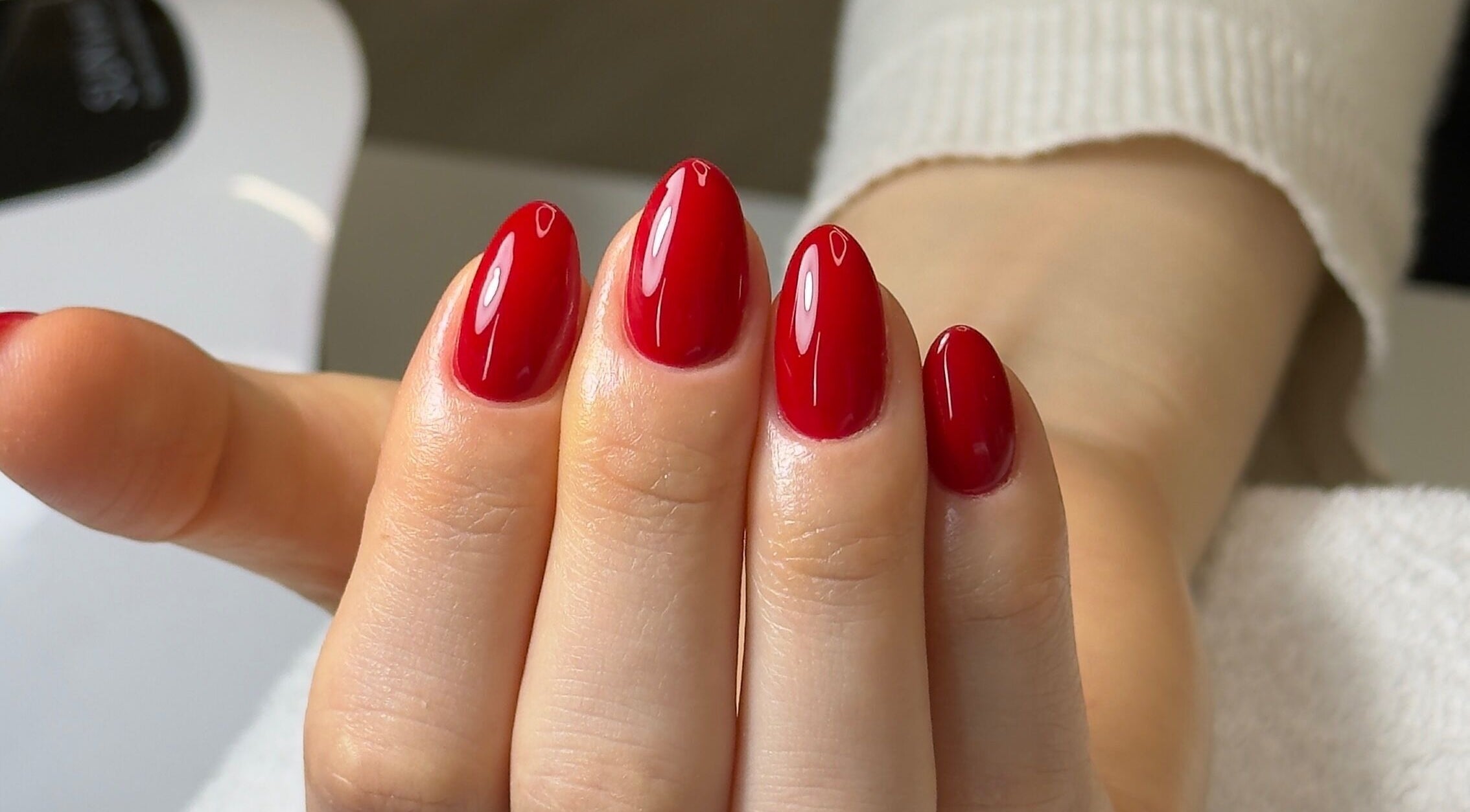 Glossy red nails at Ana Fernandes, Dublin 01, IE. Experience luxury nail care in a serene environment.