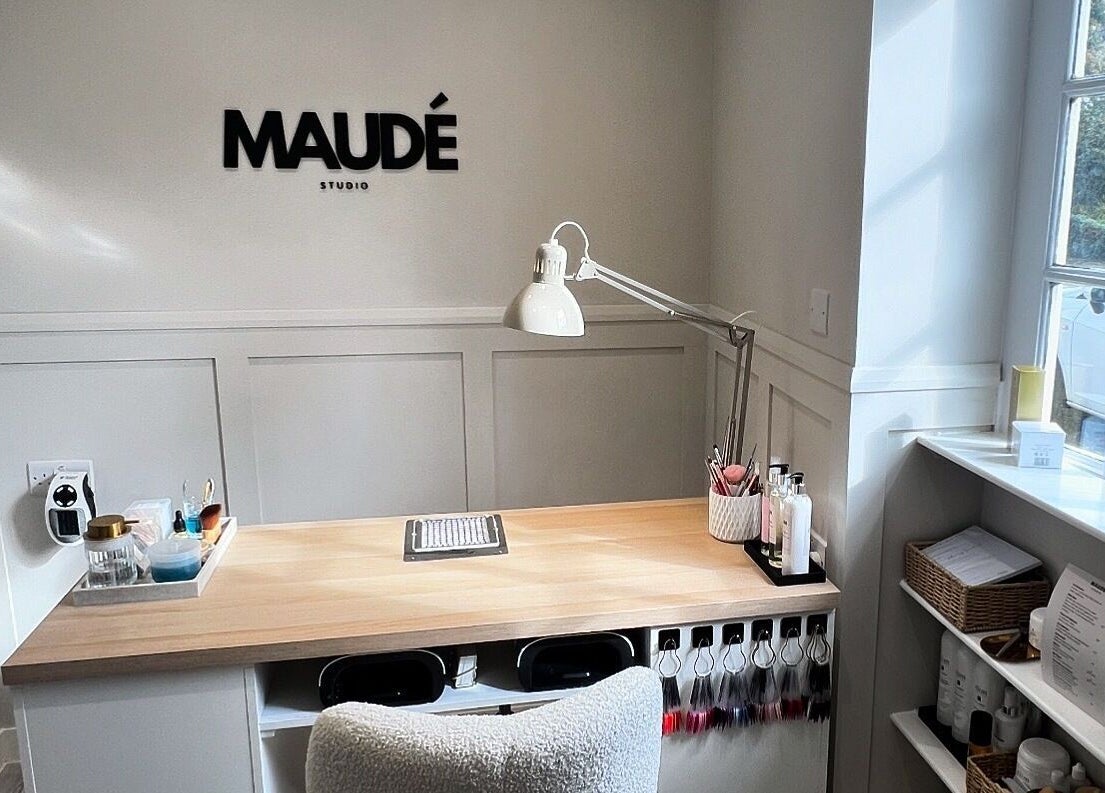 Sleek desk setup at MAUDÉ Studio, Bassingbourn, England, GB, with modern decor and organized beauty tools.