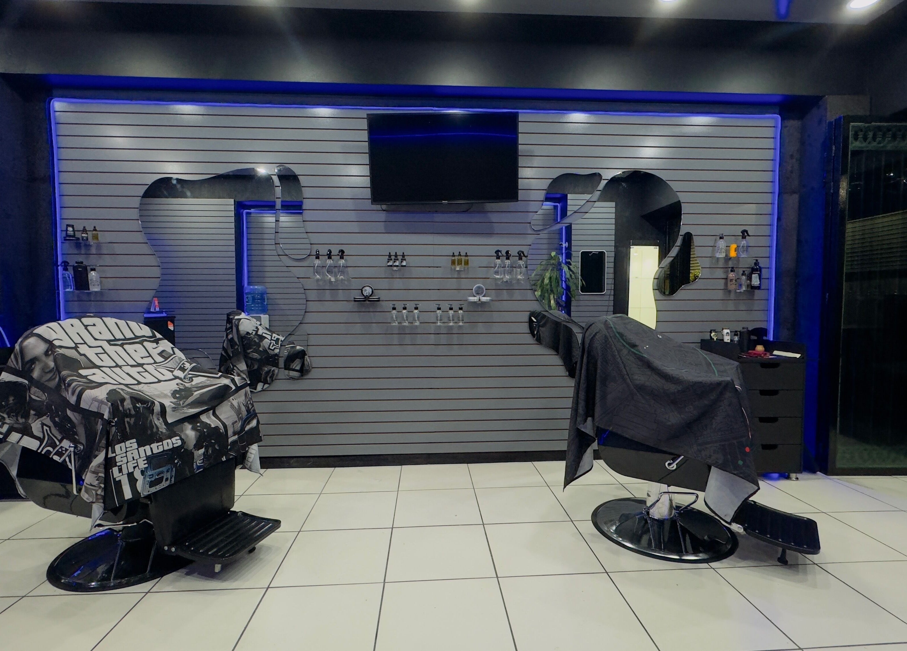 Modern barber chairs at Barberia Mercurio, Zapopan, Jalisco, MX with ambient lighting and sleek decor.