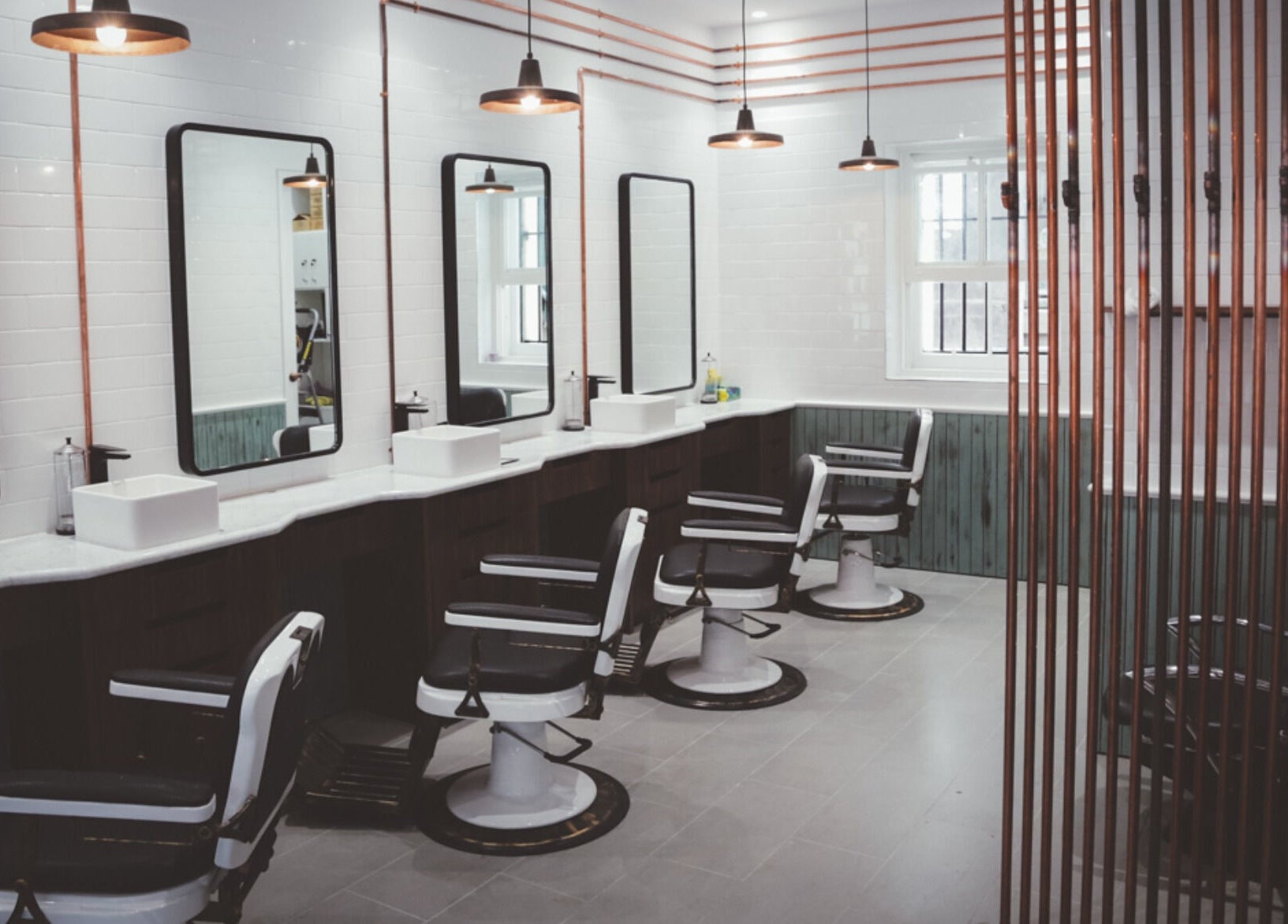 Sleek and modern interior of Alpha Barbers - Flinders Lane in Melbourne, Victoria, AU with stylish barber chairs.
