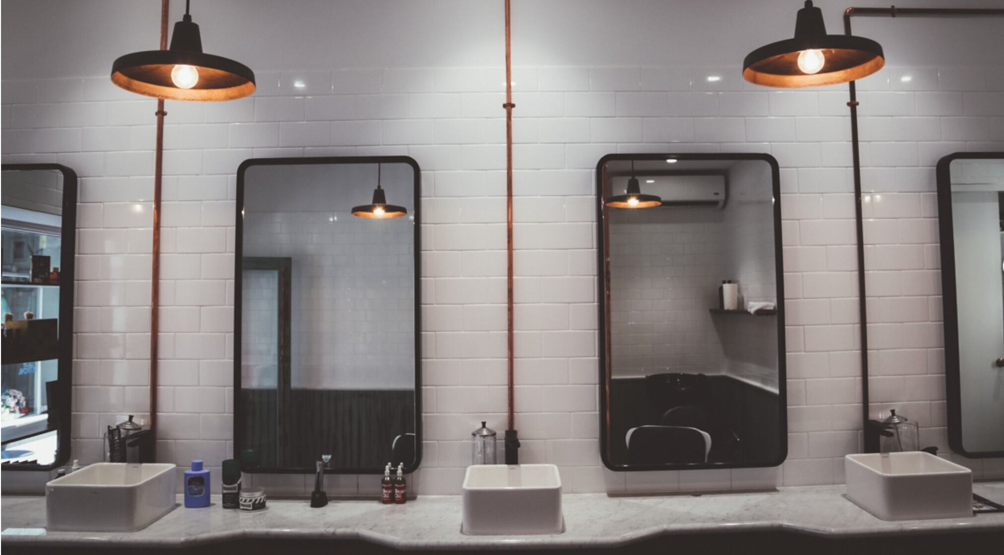 Elegant interior of Alpha Barbers - Flinders Lane, featuring mirrors and sinks in Melbourne, Victoria, AU.