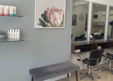 Modern salon interior at R Hair 4 U, Normanhurst, NSW, AU with styling chairs and elegant decor.