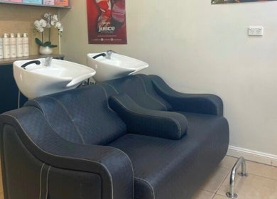 Luxurious rinse station at R Hair 4 U, Normanhurst, NSW, AU, featuring plush seating and modern design.