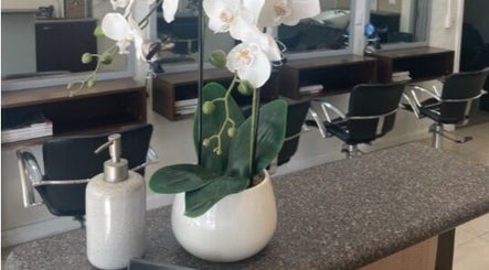 Chic salon counter with orchid at R Hair 4 U, Normanhurst, NSW, AU, showcasing elegance and comfort.