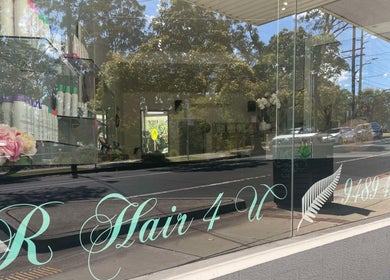 Front window of R Hair 4 U, Normanhurst, NSW, AU, displaying hair products and elegant signage.