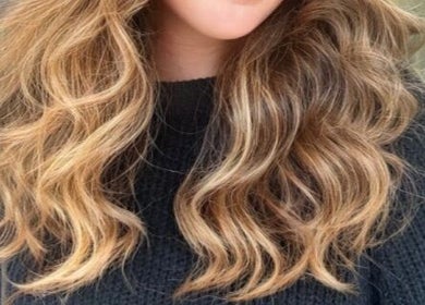 Stylish blonde highlights on wavy hair at R Hair 4 U in Normanhurst, NSW, AU.