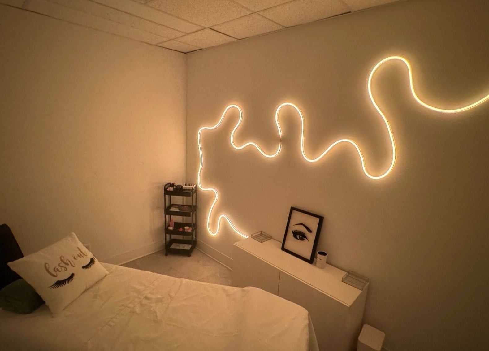 Tranquil treatment room at Blissful Spa, Saskatoon, Saskatchewan, CA, featuring cozy bed and artistic lighting.