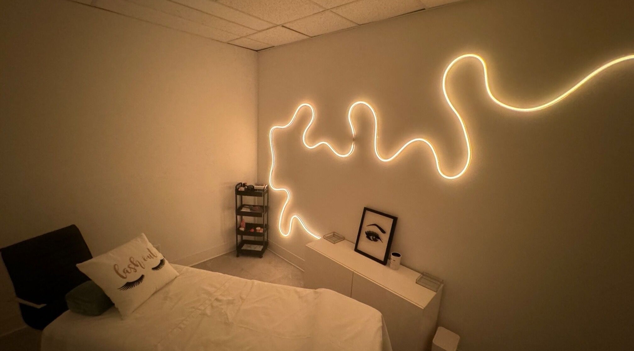 Tranquil treatment room at Blissful Spa, Saskatoon, Saskatchewan, CA, featuring cozy bed and artistic lighting.