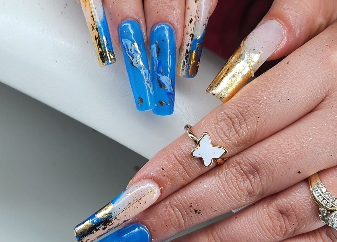 Blue and gold marble nail art at Blissful Spa, Saskatoon, Saskatchewan, CA showcasing elegant design.