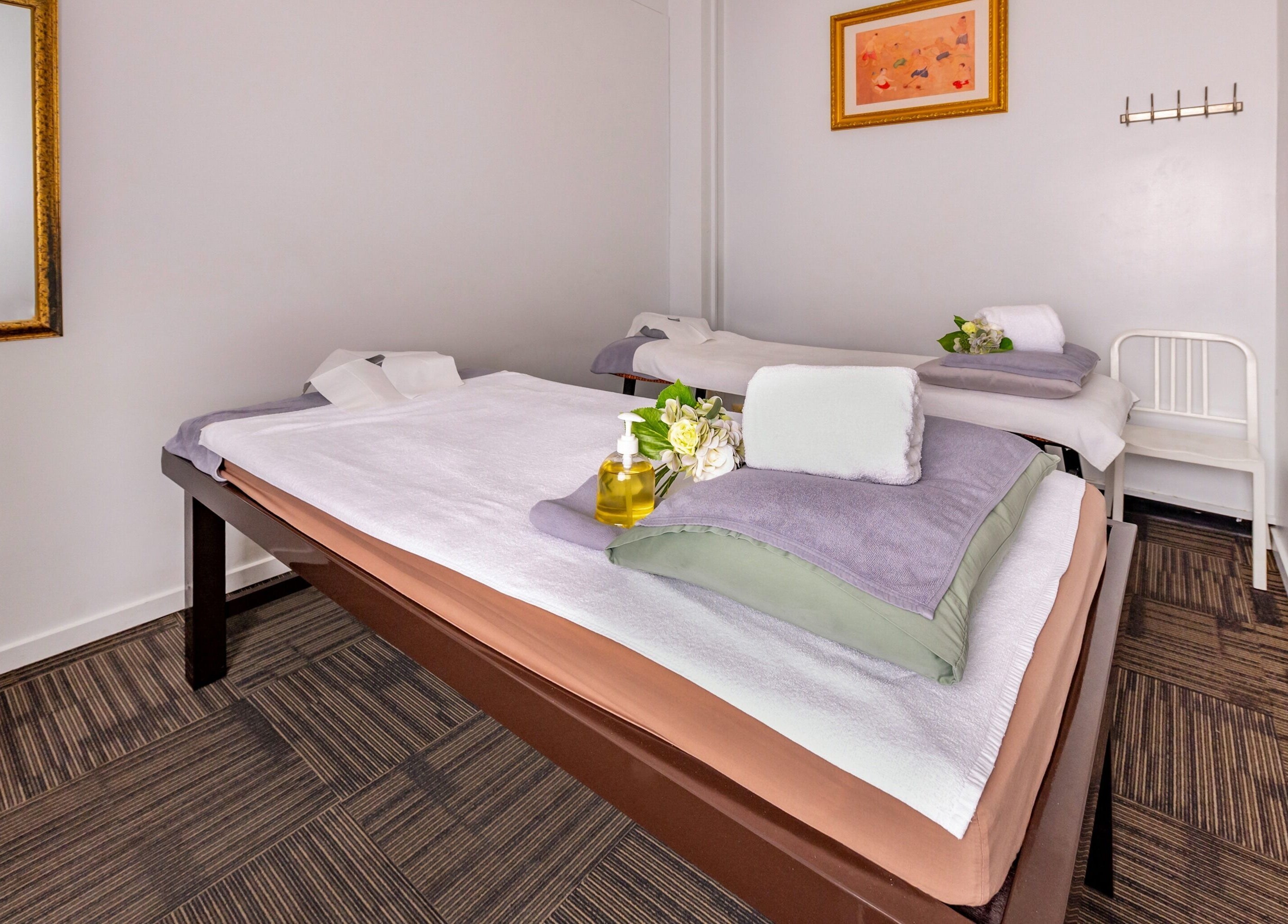 Relaxing massage room at Vigorous Thai - West Melbourne, Victoria, AU with neatly arranged towels and oils.