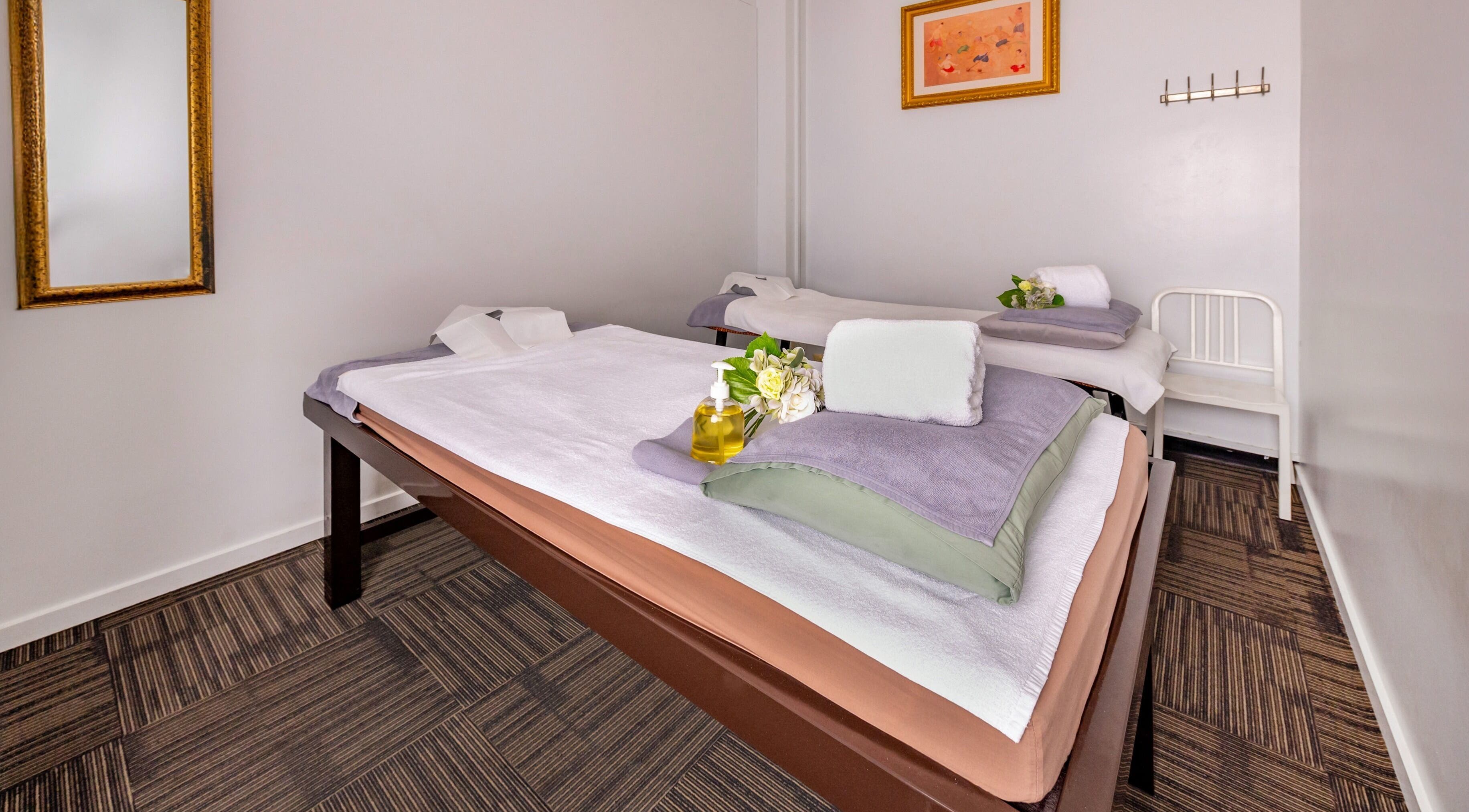 Relaxing massage room at Vigorous Thai - West Melbourne, Victoria, AU with neatly arranged towels and oils.