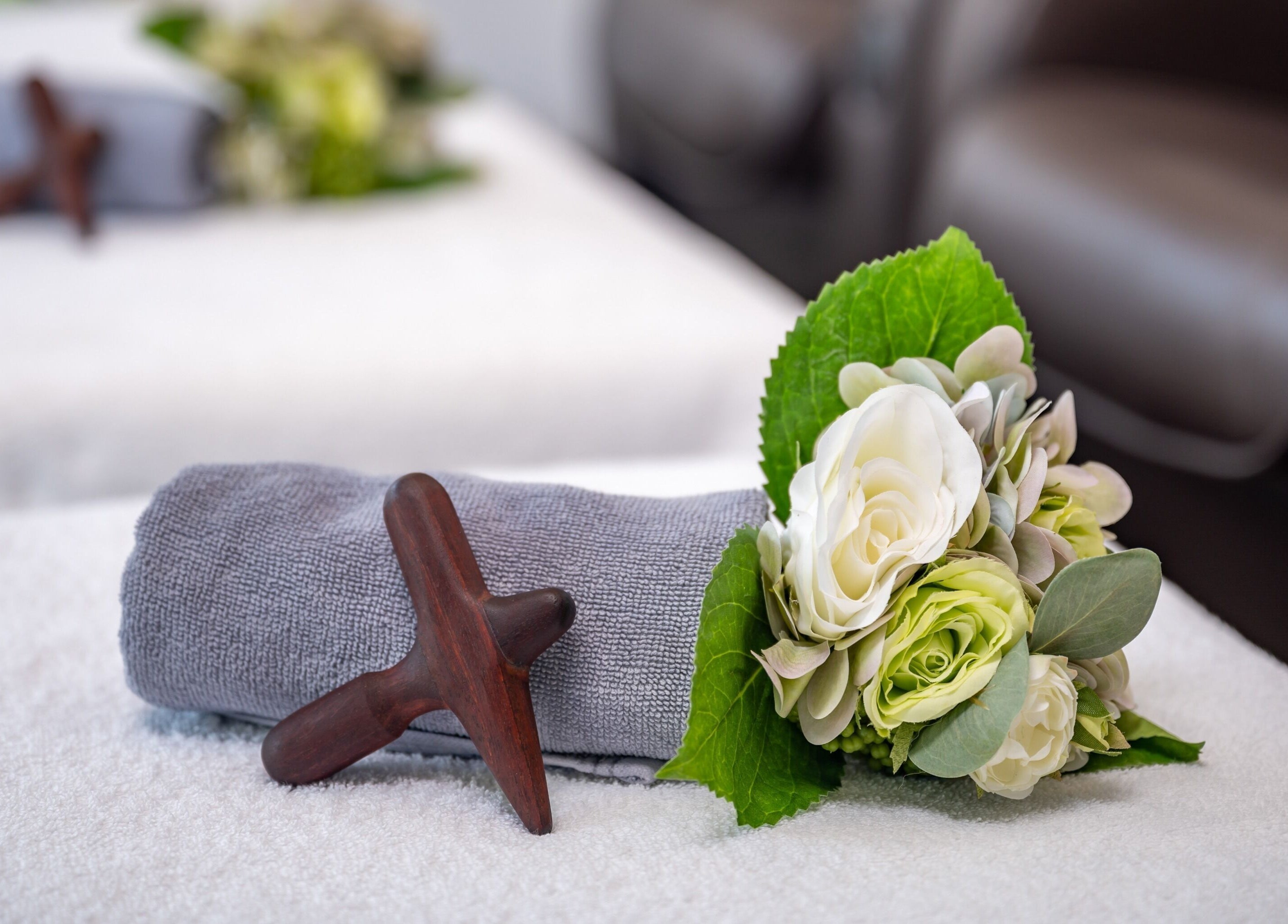 Elegant spa setup with flowers and towel at Vigorous Thai - West Melbourne, West Melbourne, Victoria, AU.