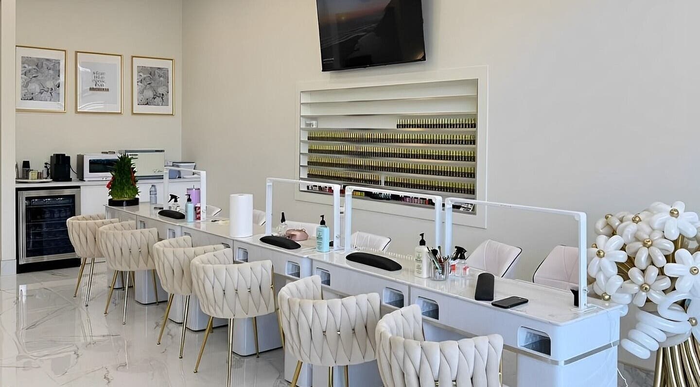 Modern nail salon interior at La Crème Nail Bar in Leduc, Alberta, CA, featuring plush chairs and elegant decor.