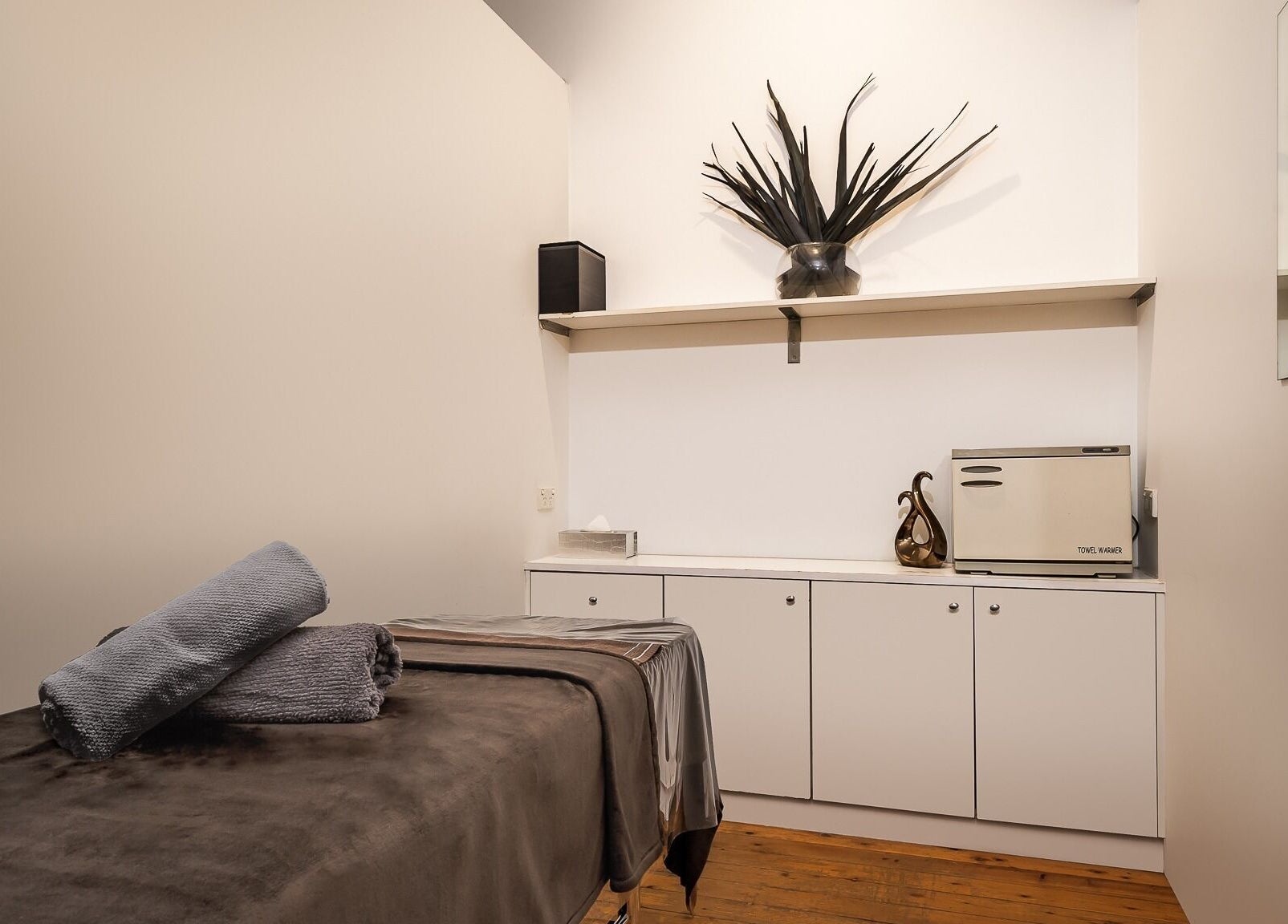 Peaceful treatment room at Diva Face and Body Clinic in Strathfield, New South Wales, AU, showcasing a massage table and decor.