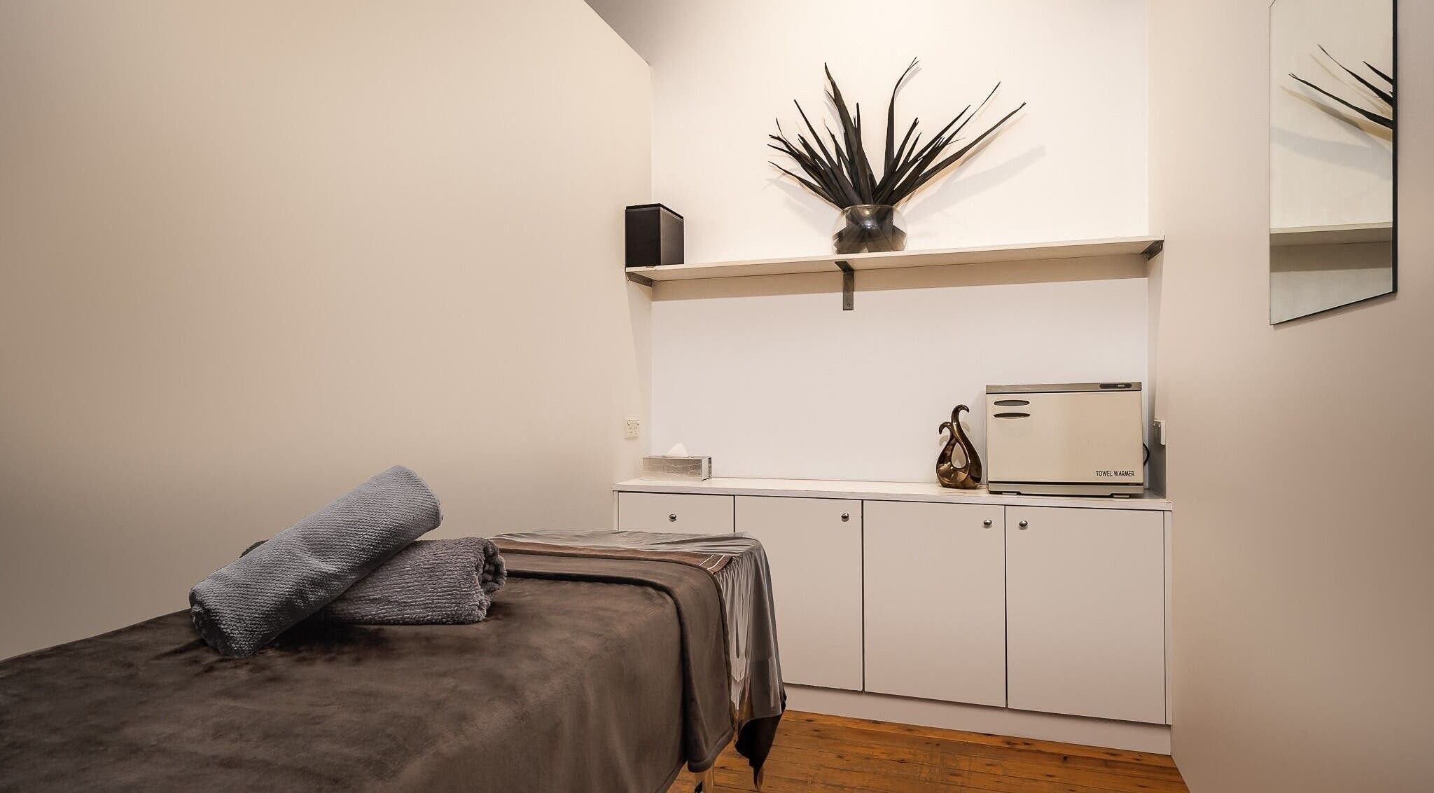 Peaceful treatment room at Diva Face and Body Clinic in Strathfield, New South Wales, AU, showcasing a massage table and decor.