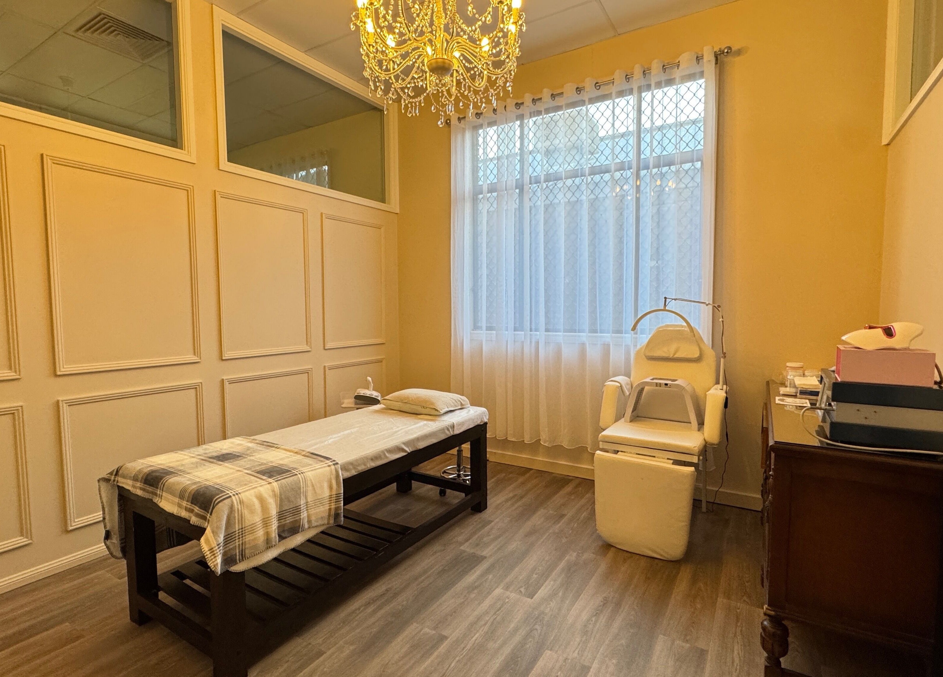 Relaxing spa room at Jaywa Wellness Centre Dubbo, Dubbo, New South Wales, AU, featuring a massage bed and chandelier.