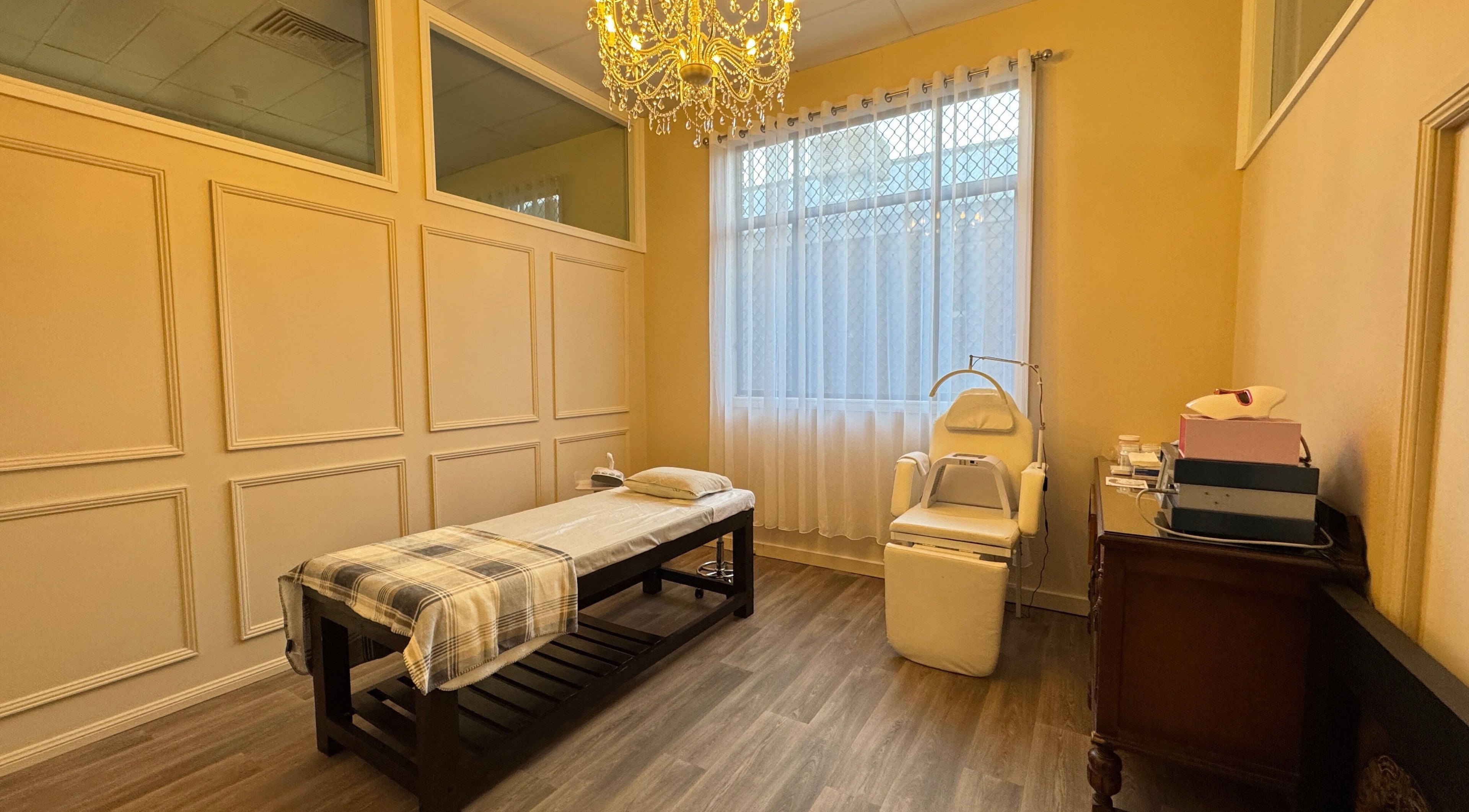 Relaxing spa room at Jaywa Wellness Centre Dubbo, Dubbo, New South Wales, AU, featuring a massage bed and chandelier.