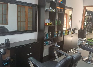 Modern interior of Meneer Barbershop with stylish chairs in Boksburg, Gauteng, ZA.