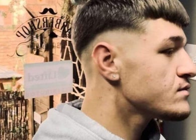 Stylish haircut at Meneer Barbershop, Boksburg, Gauteng, ZA, showcasing sharp fade and modern style.