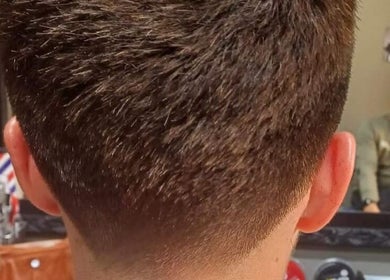 Close-up view of a fresh haircut at Meneer Barbershop, Boksburg, Gauteng, ZA, showcasing meticulous styling.