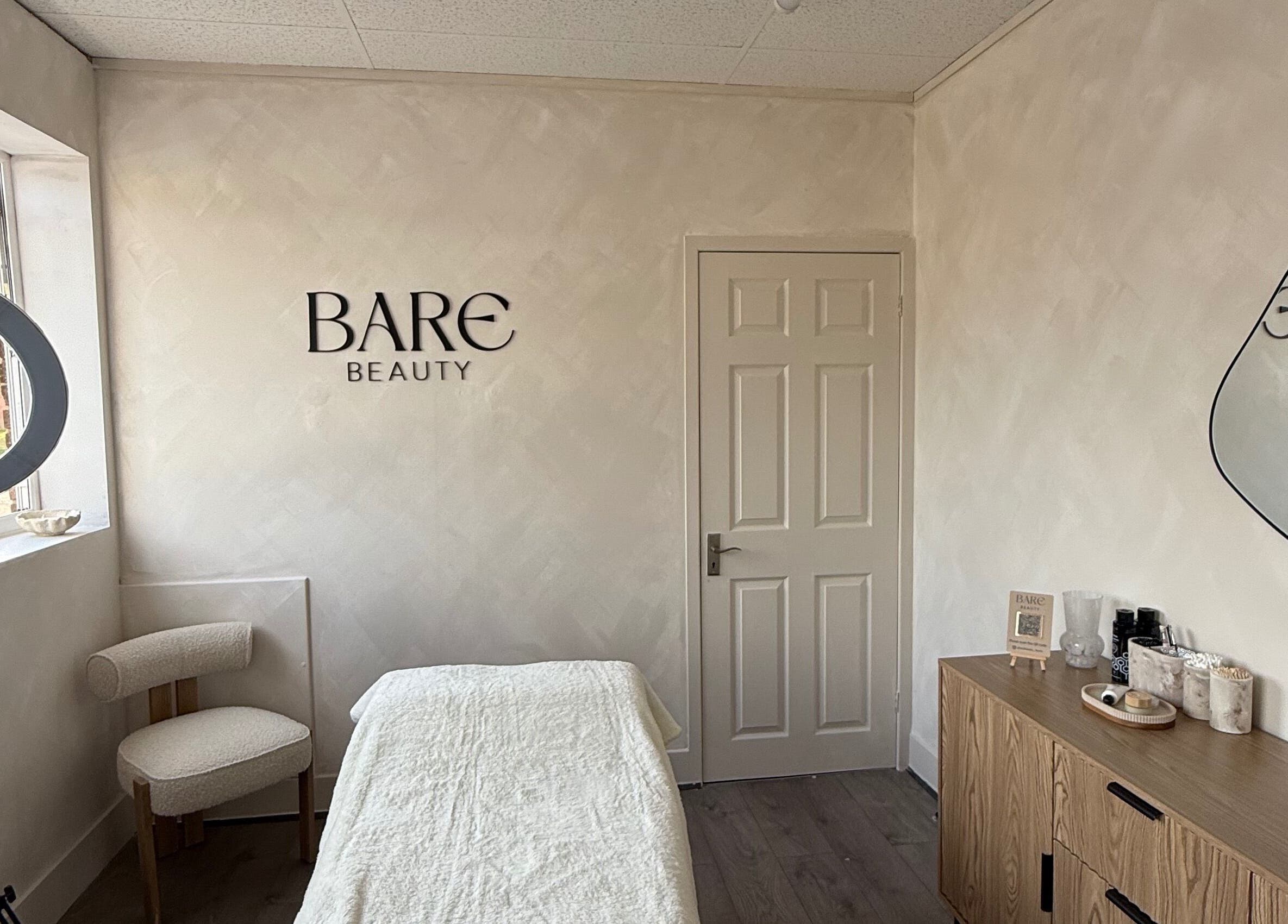 Cozy treatment room at Bare Beauty by Vici, Andover, England, GB with soft lighting and elegant decor.