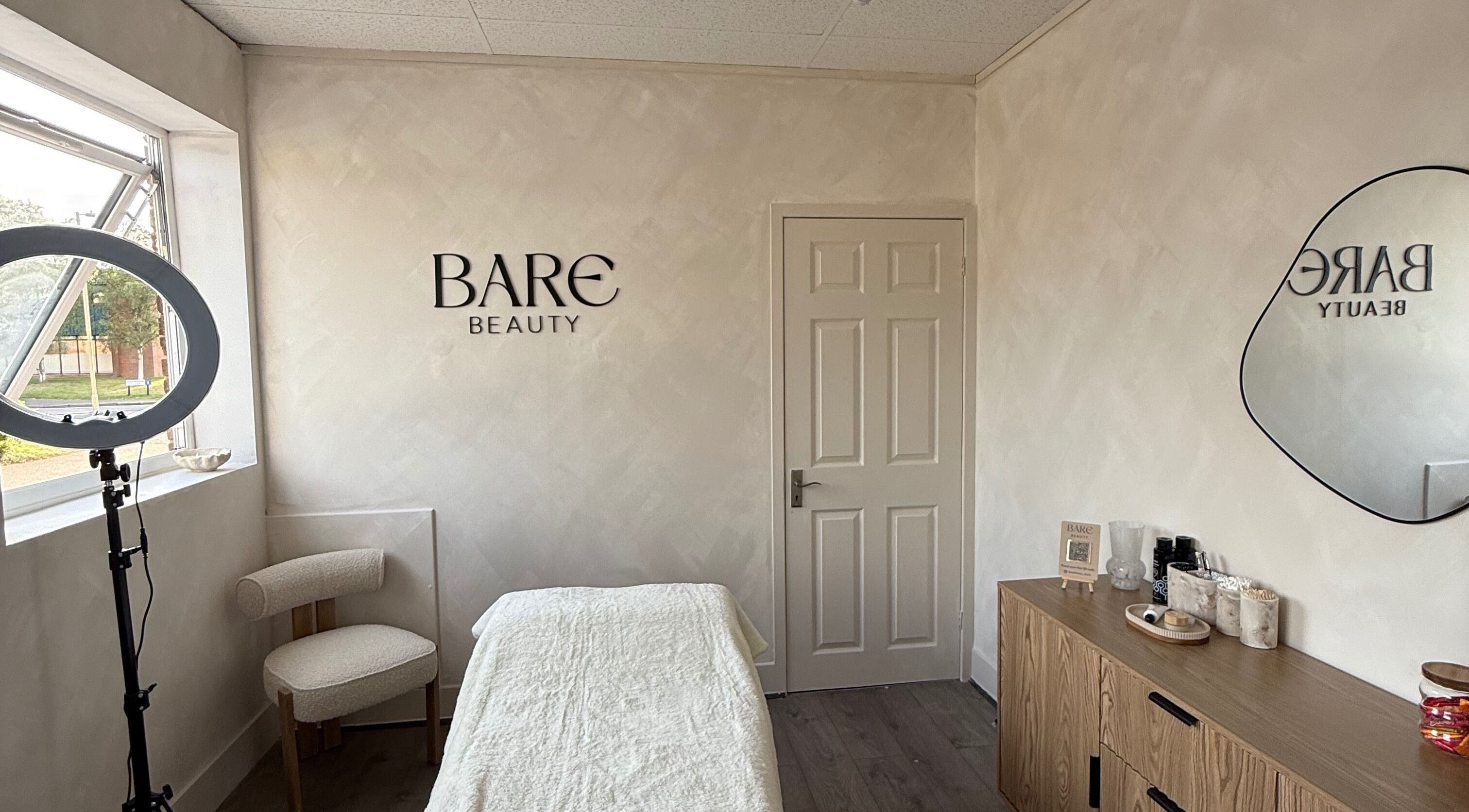 Cozy treatment room at Bare Beauty by Vici, Andover, England, GB with soft lighting and elegant decor.