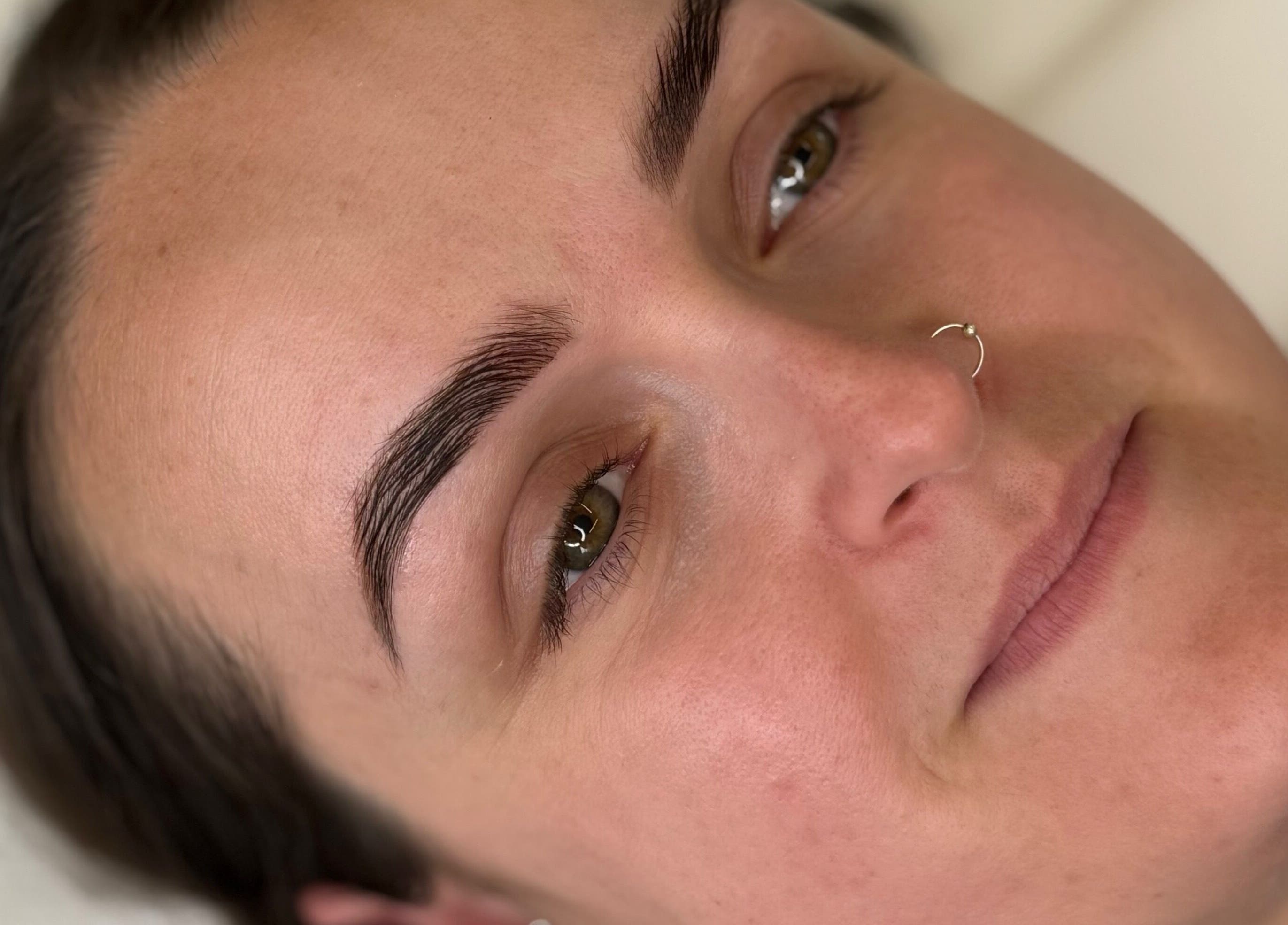 Close-up of perfectly shaped eyebrows after a beauty treatment at Bare Beauty by Vici, Andover, England, GB.