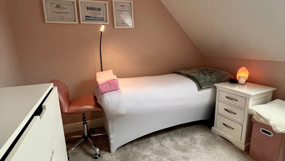 Cozy treatment room at J Lash in Dunleer, County Louth, IE with bed, chair, and soft lighting.