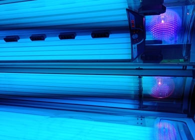 Tanning bed interior with glowing lights at Eclipse Tanning Studio, Launceston, Cornwall, GB.