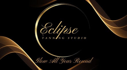 Elegant logo of Eclipse Tanning Studio Ltd, Launceston (Anglia), Cornwall with golden waves and text.