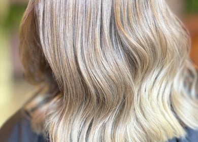 Silky blond hair styled at V•Hair Studio ByVera in Melbourne, Victoria, AU, showcasing smooth, wavy texture.