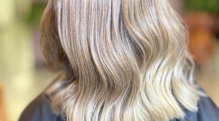 Silky blond hair styled at V•Hair Studio ByVera in Melbourne, Victoria, AU, showcasing smooth, wavy texture.