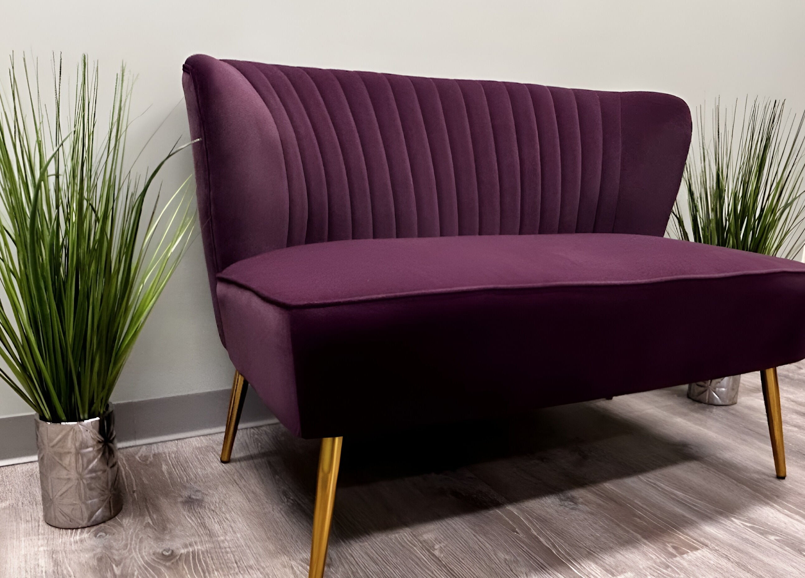 Elegant purple sofa at Bonita Hub, Rolling Meadows, Illinois, US, enhancing a serene lobby space.