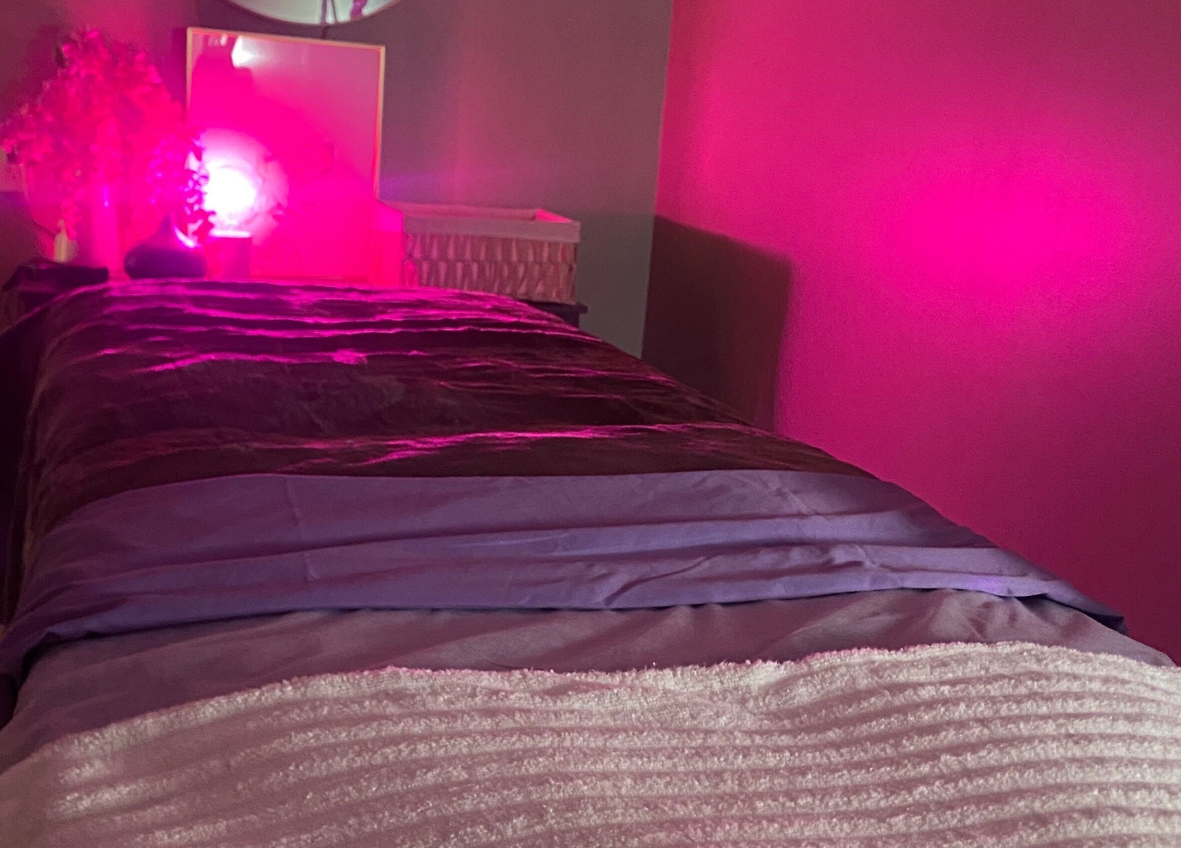 Massage table in a softly lit room at Bonita Hub, Rolling Meadows, Illinois, US, with serene pink ambiance.